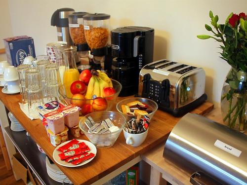 a kitchen counter filled with fruit and vegetables at Edinburgh Holiday Guest House in Edinburgh