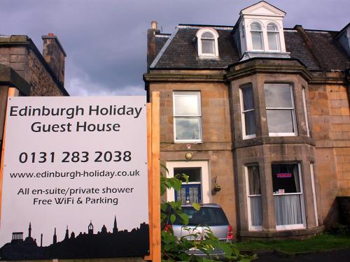 un cartel frente a una casa con una casa de huéspedes en Edinburgh Holiday Guest House, en Edimburgo