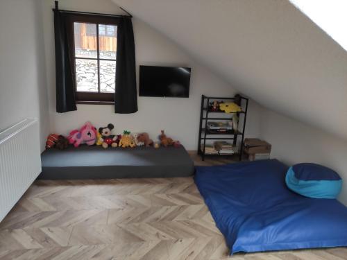 a room with a bed and a window at Kamenná stráň in Metylovice