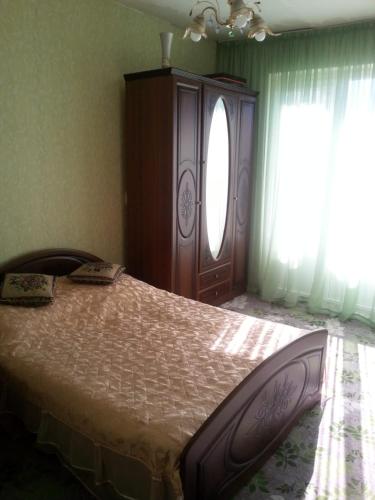 A bed or beds in a room at Квартира у Светы