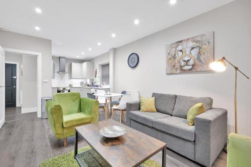 a living room with a couch and a table at Crown Place 2 & 3 Bedroom Luxury Apts with Parking in Shepperton By 360Stays in Shepperton