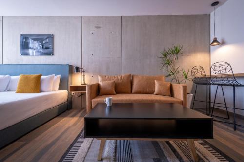 a living room with a bed and a couch at ParkLife Condesa Hipódromo in Mexico City