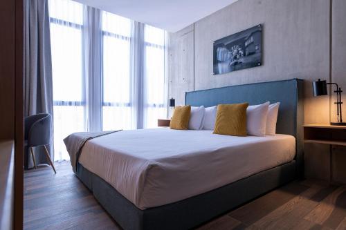 a bedroom with a large bed with a large window at ParkLife Condesa Hipódromo in Mexico City
