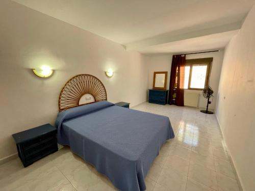 a bedroom with a large bed with a blue blanket at Villa June in Benitachell