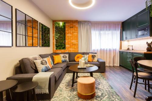 a living room with a couch and a table at Fly Rooms Madrid Airport in Madrid