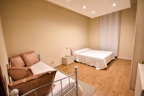a small bedroom with a bed and a chair at Piccola Perla sul Lago Maggiore in Arona