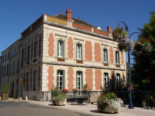 a large brick building with flowers in front of it at Beautiful large stylish villa centrally located in Pons in Pons