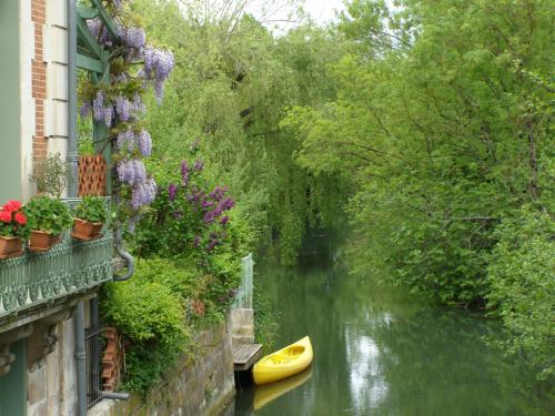 a river with a yellow boat on the side of a building at Beautiful large stylish villa centrally located in Pons in Pons