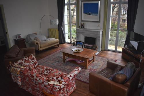 a living room with couches and a table and a fireplace at Beautiful large stylish villa centrally located in Pons in Pons