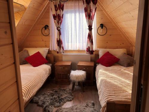 um quarto com 2 camas num chalé de madeira em Chałupy Na Brzyzku em Poronin