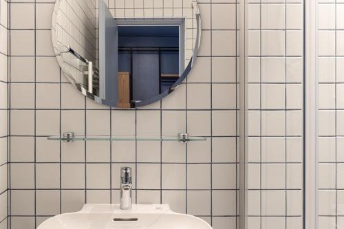 a bathroom with a sink and a mirror at Cusanus Akademie - Accademia Cusanus in Bressanone