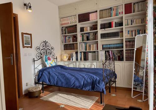 a bedroom with a bed in a room with bookshelves at La terrazza di Anna in Sassari