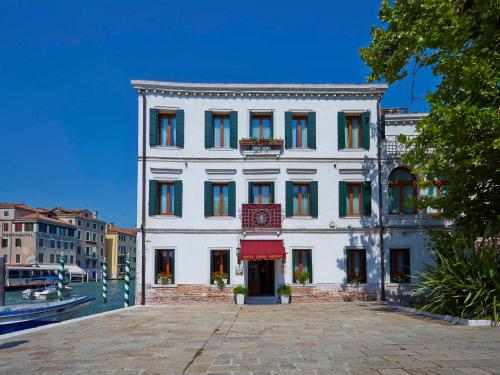 a large white building with a clock on it at Canal Grande in Venice