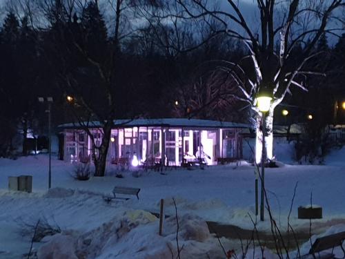 a lit up building in the snow at night at FeWo Nina Exklusiv Design mit Bergblick in Goslar