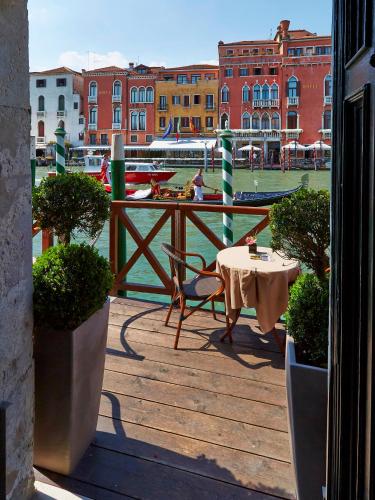 a balcony with a table and a view of a harbor at Canal Grande in Venice