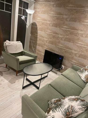 a living room with a couch and a table at Villa Båthamnsgatan in Söråker