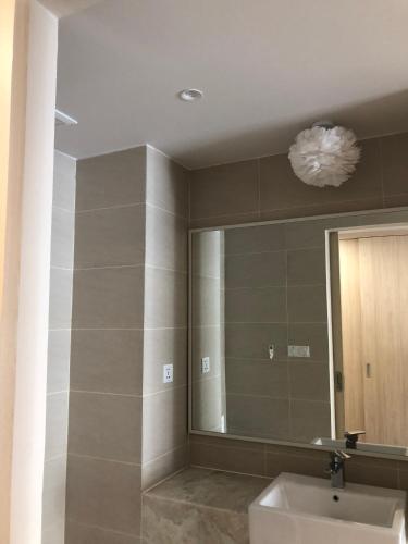 a bathroom with a sink and a mirror at Gold Coast Luxury Apartment Nha Trang in Nha Trang