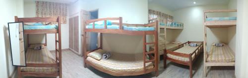 a room with three bunk beds in a room at Koinonia Retreat CenteR in Baguio