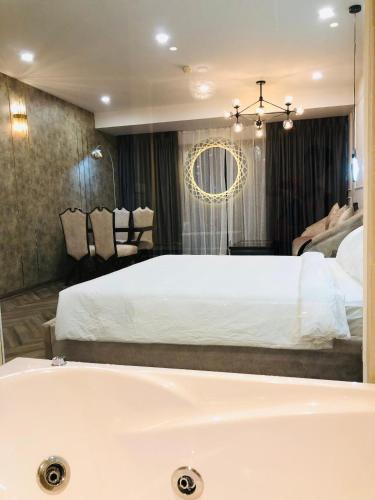 a bedroom with a bed and a bath tub at Gold Coast Luxury Apartment Nha Trang in Nha Trang