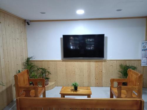 a room with two tables and a tv on a wall at Koinonia Retreat CenteR in Baguio