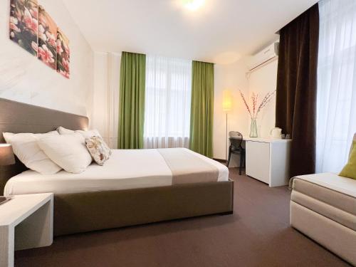 a hotel room with a bed and a desk at Centar Forever in Belgrade
