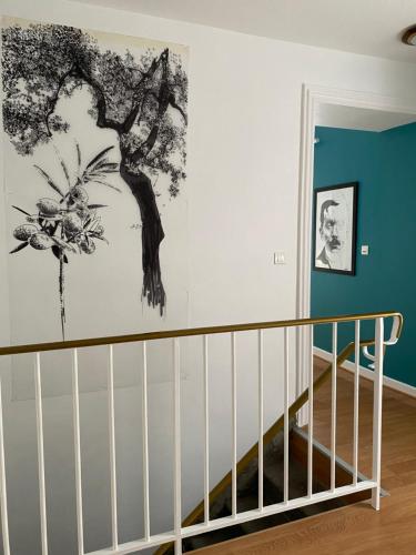 a staircase in a room with a painting on the wall at A l'Aube des Volcans in Charbonnières-les-Vieilles