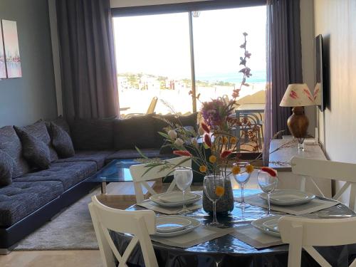 a living room with a table and a couch at Duquesa village El Hacho in Manilva