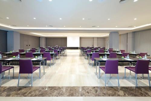 a conference room with tables and purple chairs at InterContinental Barcelona by IHG in Barcelona