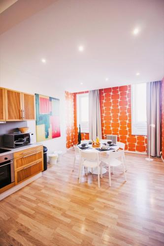 a kitchen with a white table in a room at Central and Cozy in Brussels in Brussels