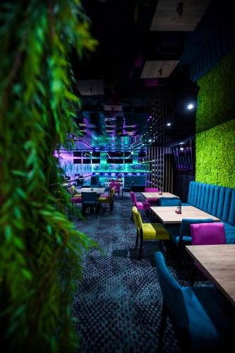 a dining room with tables and chairs and lights at Grand Laola Spa in Pobierowo