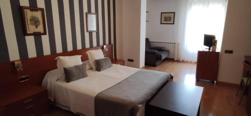 a hotel room with a bed with two pillows on it at Hotel Segle XX in Tremp
