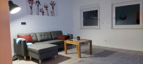 a living room with a couch and a table at Ferienwohnung KaMa in Bitburg
