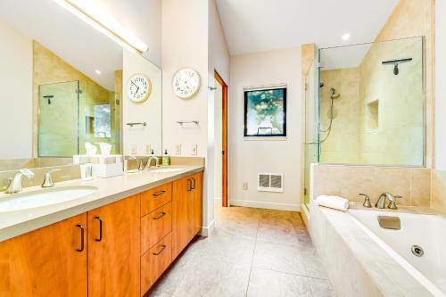 a bathroom with two sinks and a tub and a shower at Seaspray in Sea Ranch