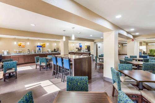 a restaurant with tables and chairs and a bar at Quality Inn Charleston South in Charleston