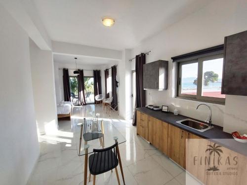 a kitchen with a sink and a counter top at Finikas Suites & Apartments Airport By Airstay in Artemida