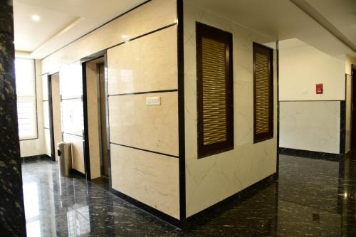a hallway with a row of doors in a building at Hotel U.T.ELITE in Bengaluru