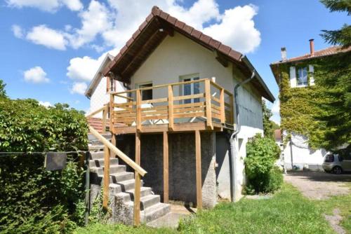 a house with a deck on the side of it at Une Tiny House à découvrir au cœur de la cité ! in Contrexéville