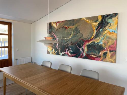 a dining room with a table and a painting on the wall at Reykjavík Central Apartments in Reykjavík
