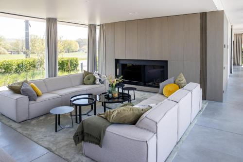 uma sala de estar com dois sofás e uma lareira em GLUK em Zonnebeke