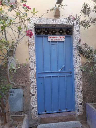a blue door on the side of a building at La maison des amis in Taroudant
