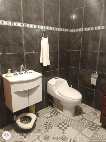 a bathroom with a toilet and a sink at Alborada Hostel in Resistencia
