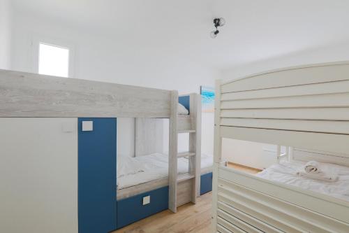 a bunk bed with two bunk beds in a room at Maison tout confort a deux pas de la piste cyclable in Le Bois-Plage-en-Ré