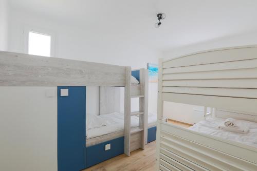 a bunk bed with two bunk beds in a room at Maison tout confort 4 adultes et 4 enfants in Le Bois-Plage-en-Ré