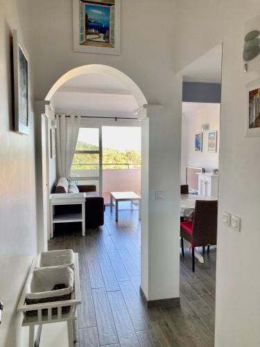 a living room with a couch and a table at Les Restanques vue mer Pressoir 3131 in Grimaud