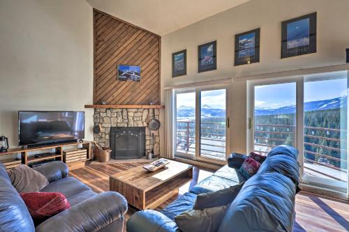 a living room with a couch and a tv and a fireplace at Near Hiking Mtn-View Condo in Silverthorne! in Silverthorne