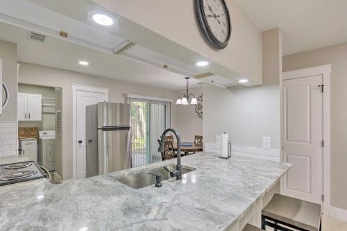 a kitchen with a sink and a clock on the wall at Fort Walton Beach Townhome Less Than 3 Mi to the Beach! in Fort Walton Beach