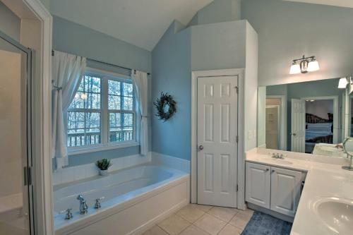 a bathroom with a tub and a sink at Family-Friendly Lake Lanier Escape on 2 and Acres! in Gainesville