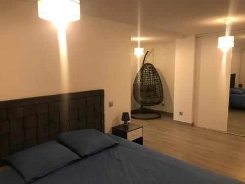 a bedroom with a bed and a chair in a room at LA CARTOUCHERIE in Toulouse