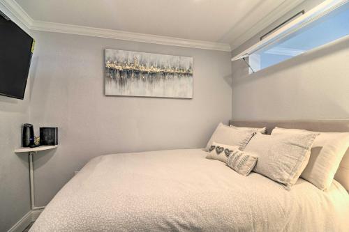 a bedroom with a bed and a painting on the wall at Beachfront Clearwater Condo with Community Pool in Clearwater Beach