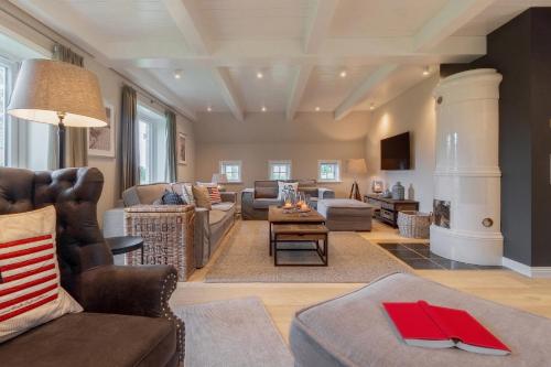 a living room with a couch and a table at Haus Eva Marie in Oldsum